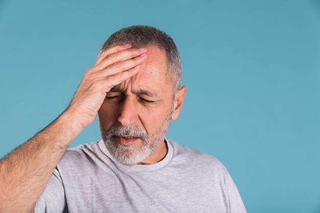 Portrait of a mature man suffering from headache