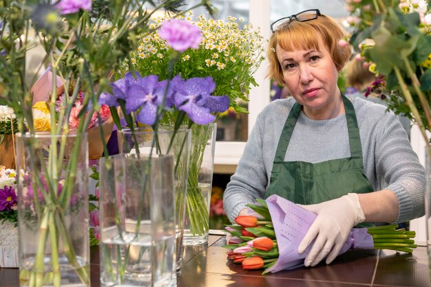 Portrait of mature woman holding flowers