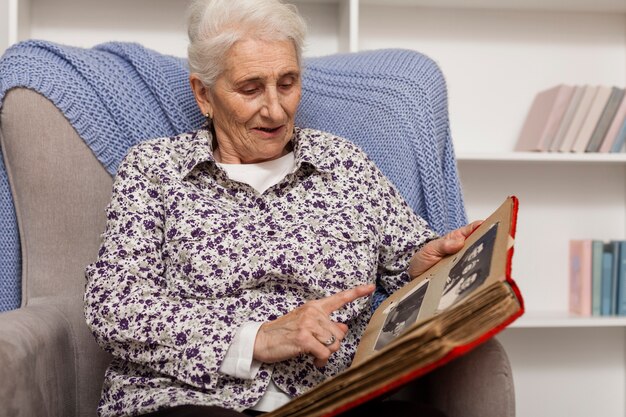 Portrait of mature woman holding photo album