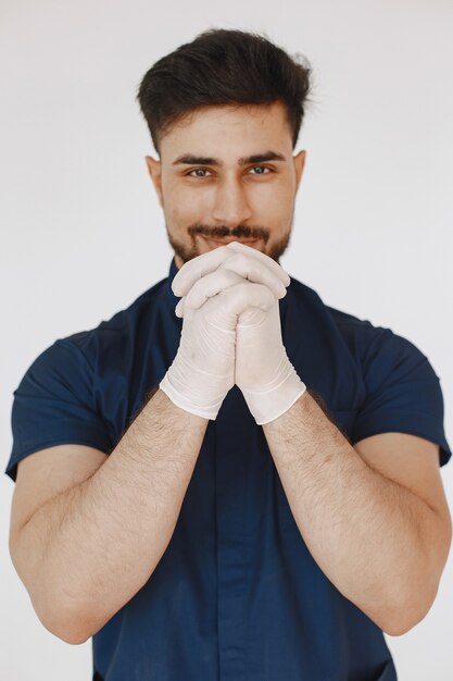 A portrait of a medical doctor posing against white background