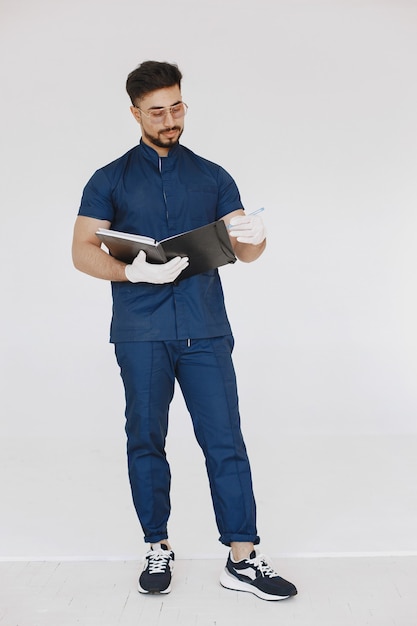 Free photo a portrait of a medical doctor posing against white wall