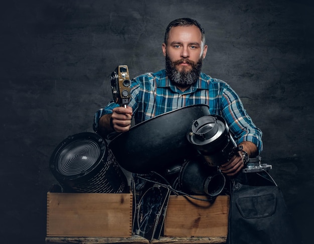 Free photo portrait of middle age man videographer in a studio.
