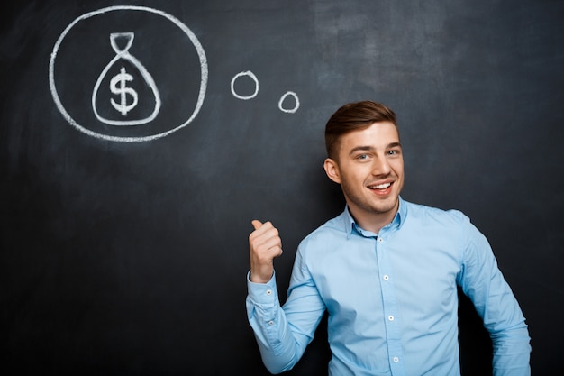 Portrait of minded man pointing on his mind about money