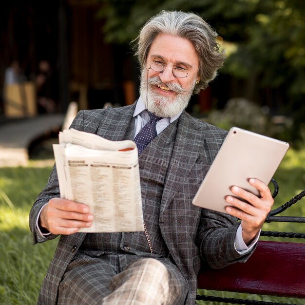 Portrait of modern man reading newspaper