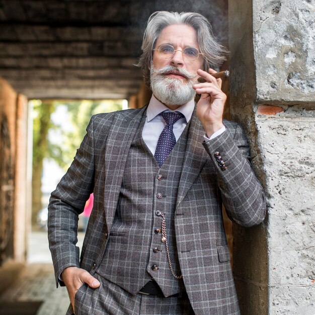 Portrait of modern man smoking cuban cigar