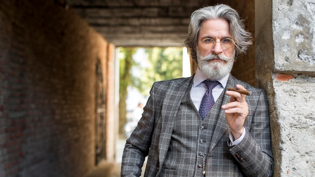 Portrait of modern man smoking cuban cigar