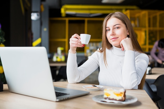 Ritratto di donna moderna che lavora con il computer portatile