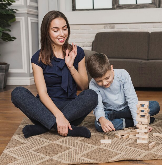 Portrait of mom watching son playing