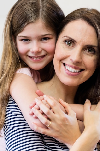 Portrait of mother and daughter embracing each other