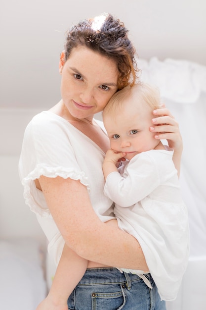 Portrait of mother holding her baby