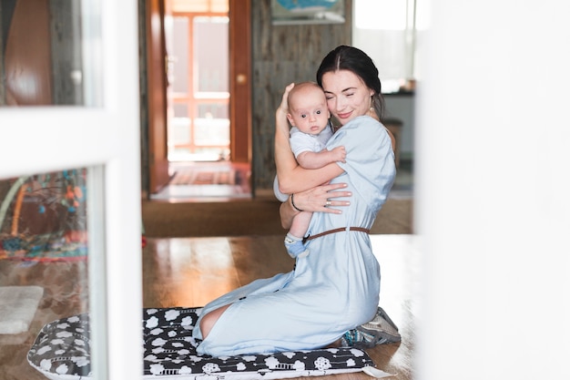 Free photo portrait of mother loving her baby at home