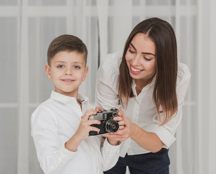 a mother teaching her son how to use camera
