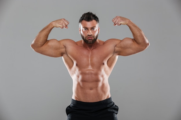 Portrait of a muscular strong shirtless male bodybuilder