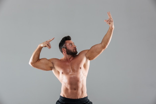 Portrait of a muscular strong shirtless male bodybuilder