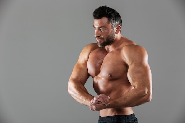 Portrait of a muscular strong shirtless male bodybuilder