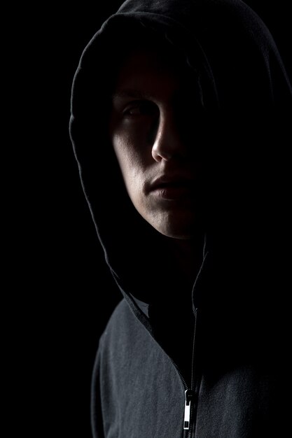 Portrait of mysterious man in the dark