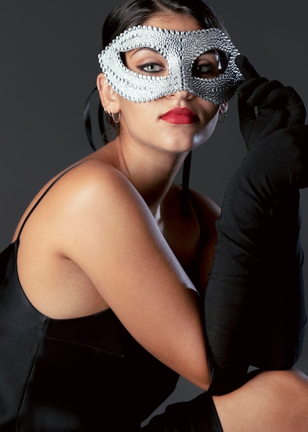 Portrait of mysterious woman with carnival mask