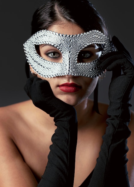 Portrait of mysterious woman with carnival mask