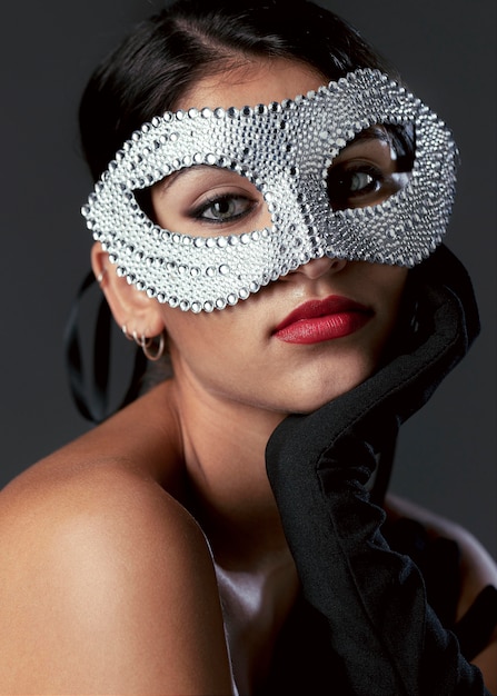 Portrait of mysterious woman with carnival mask