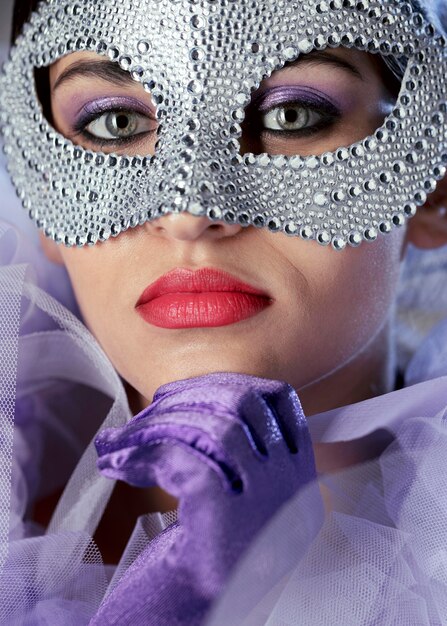 Portrait of mysterious woman with carnival mask