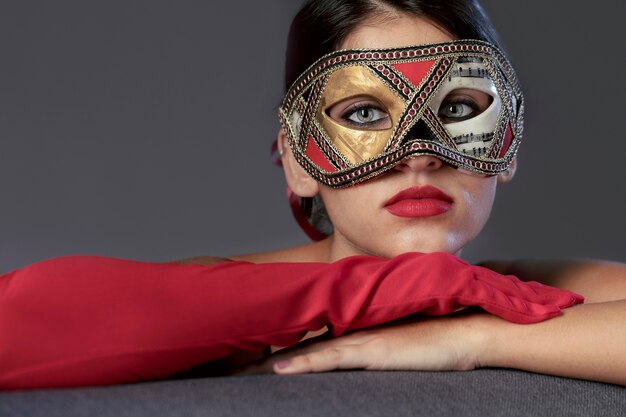 Portrait of mysterious woman with carnival mask