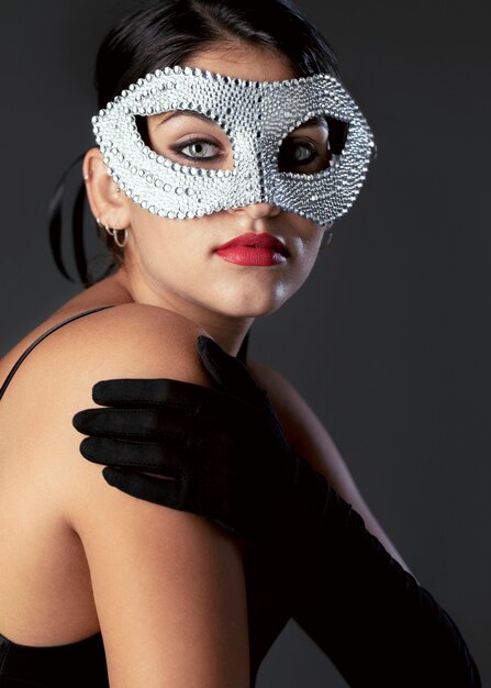 Portrait of mysterious woman with carnival mask