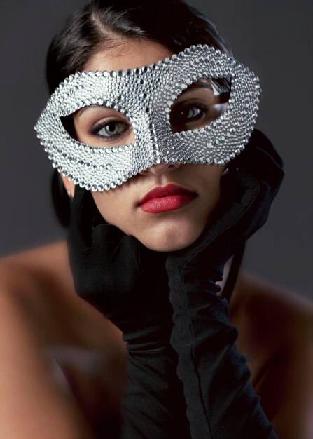 Portrait of mysterious woman with carnival mask