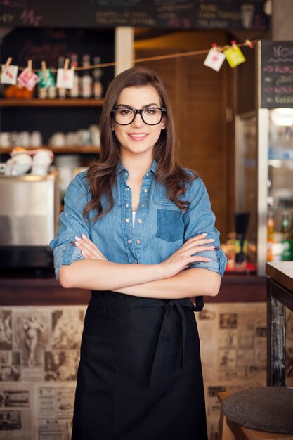 Portrait of nerdy waitress at work 
