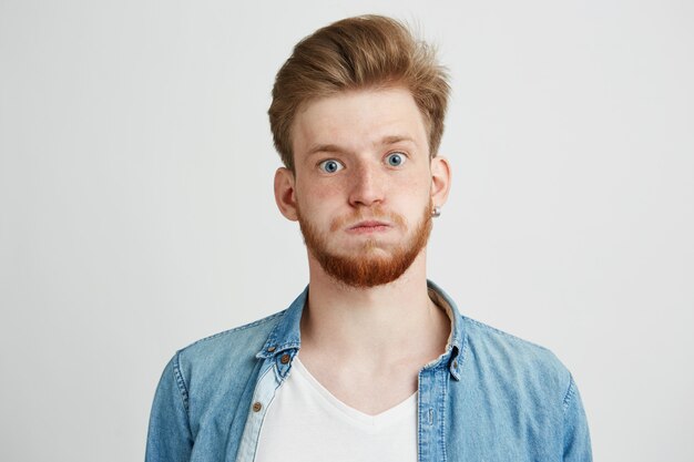 Portrait of nervous young man with beard.