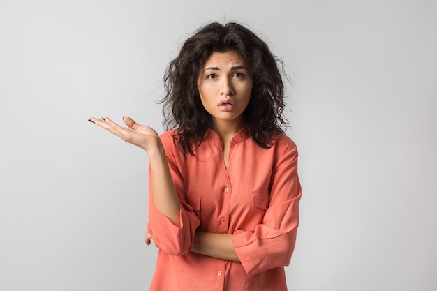 Portrait o young pretty woman, mixed race, curly hair, stressed, frustrated emotion on face, thinking about problem, isolated, orange blouse, 