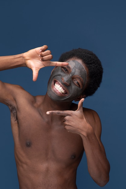 Бесплатное фото Портрет красивого мужчины с угольной маской на лице