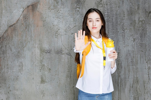 Портрет молодой женщины, держащей бутылку с водой. фото высокого качества