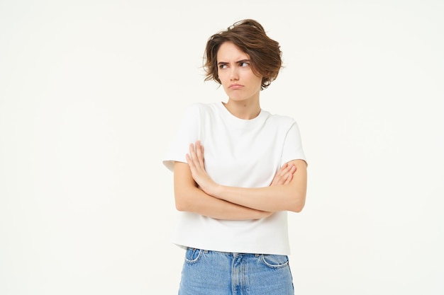 Free photo portrait of offended girl student pouting cross arms on chest and looking away standing disappointed