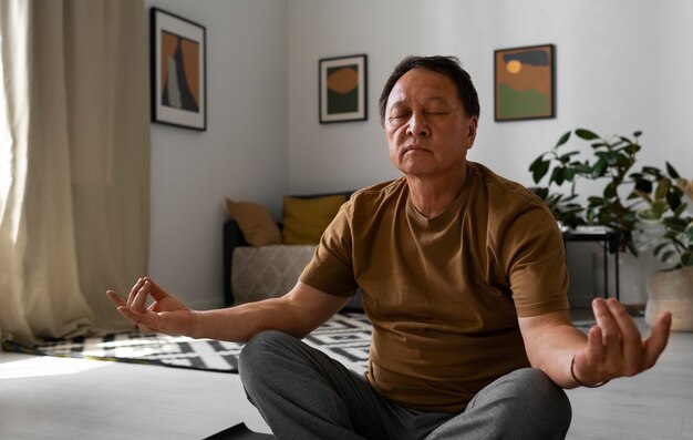 Portrait of older man meditating home