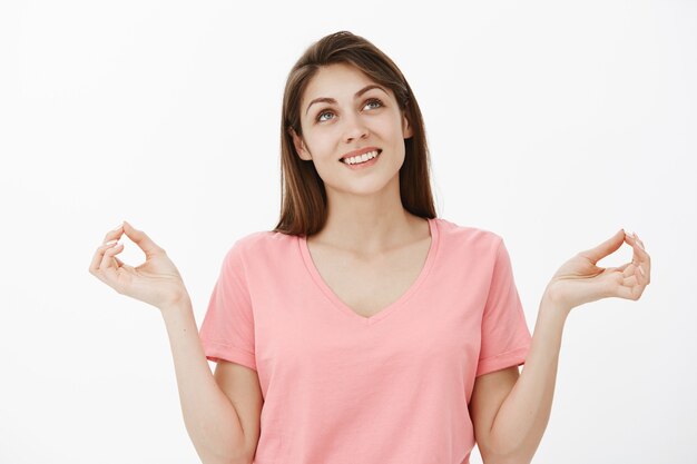 Portrait of optimistic brunette woman posing in the studio