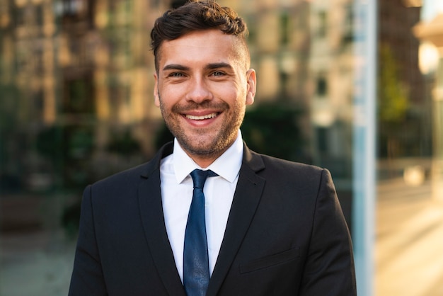 Portrait of outdoors business man smiles