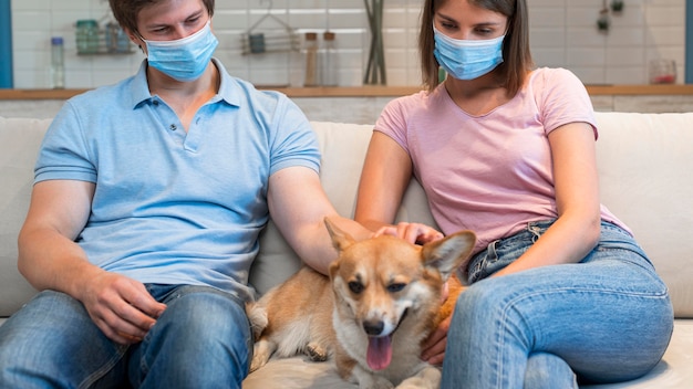 Portrait of parents petting family dog