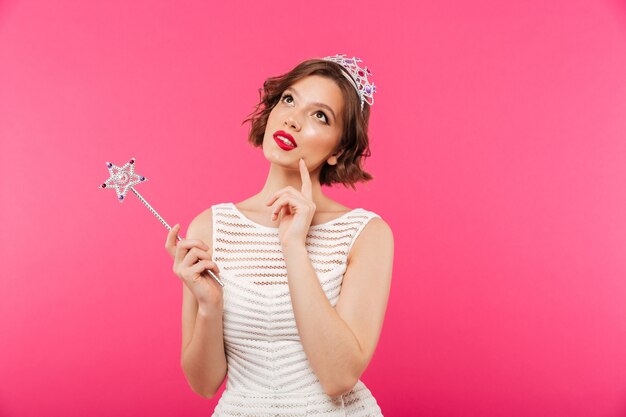 Portrait of a pensive girl wearing crown