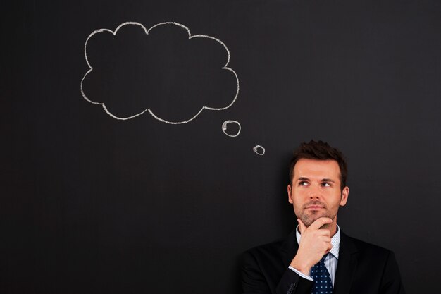 Portrait of pensive and thoughtful businessman 
