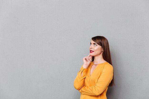 Portrait of a pensive woman looking away at copy space