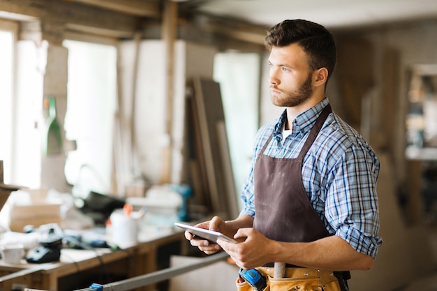 Free photo portrait of pensive woodworker