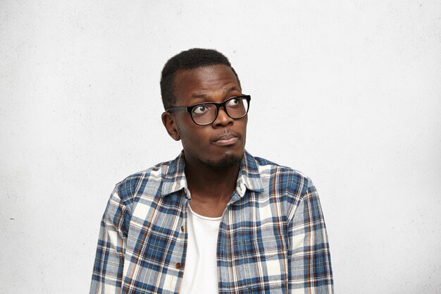 Portrait of pensive young African-American man looking up