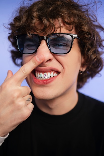 Free photo portrait of person with tooth gems