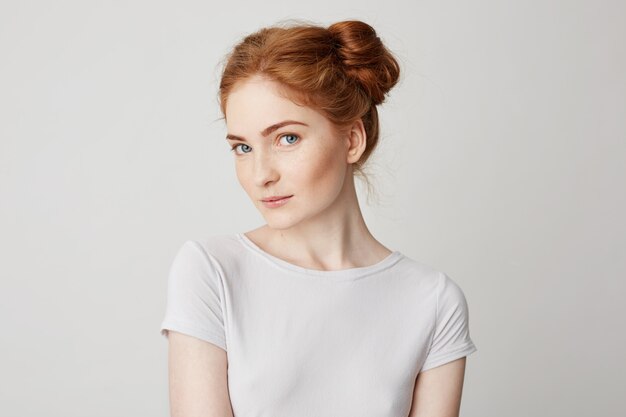 Portrait of playful beautiful young girl with red hair .