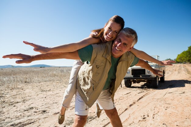 Portrait of playful couple on landscape