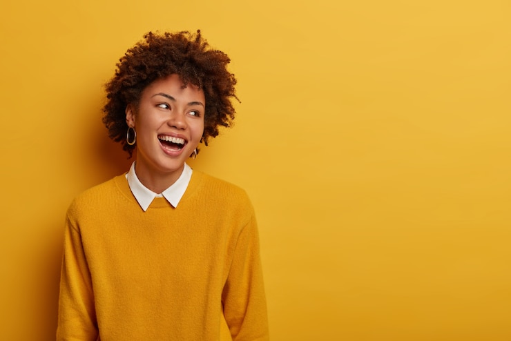 Free Photo portrait of pleasant looking overjoyed woman laughs and turns gaze aside