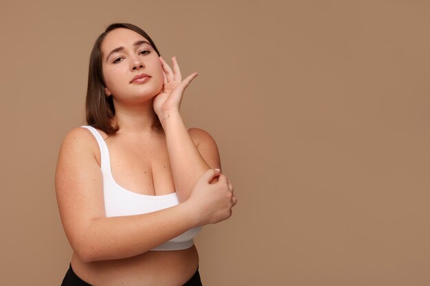 Portrait of plus size woman doing her beauty regimen and skincare routine