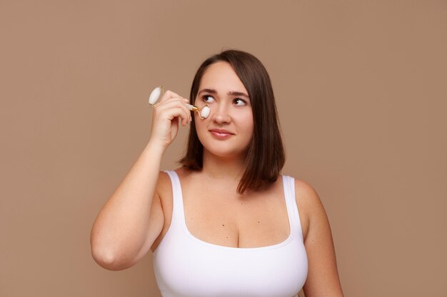 Portrait of plus size woman doing her beauty regimen and skincare routine