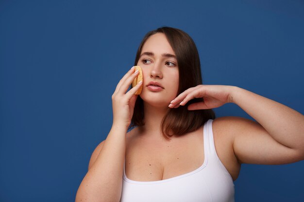 portrait of plus size woman doing her beauty regimen and skincare routine