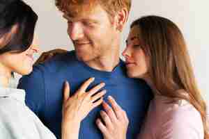 Free photo portrait of polyamorous couple at home showing affection